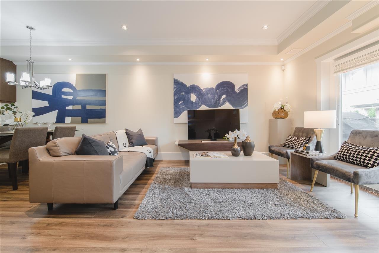 Modern living room featuring a cozy sofa, flat-screen TV, and stylish decor with soft lighting.