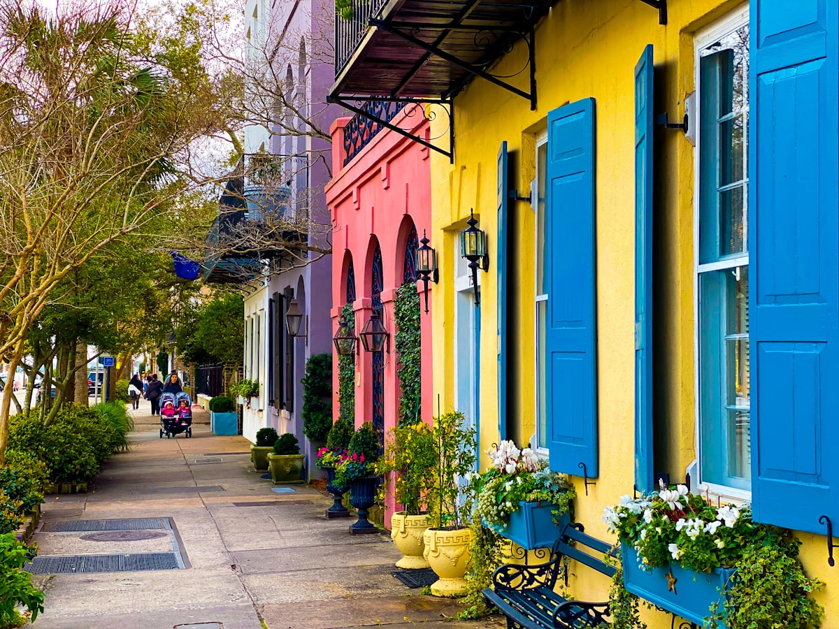 Colorful historic row houses on a Charleston street at dusk