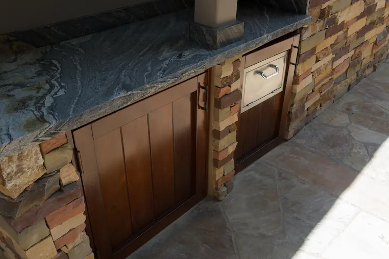 Dark stained wooded custom cabinets for the outdoor kitchen area at the Big Canyon Remodel project. Photo by Chris Darnall.