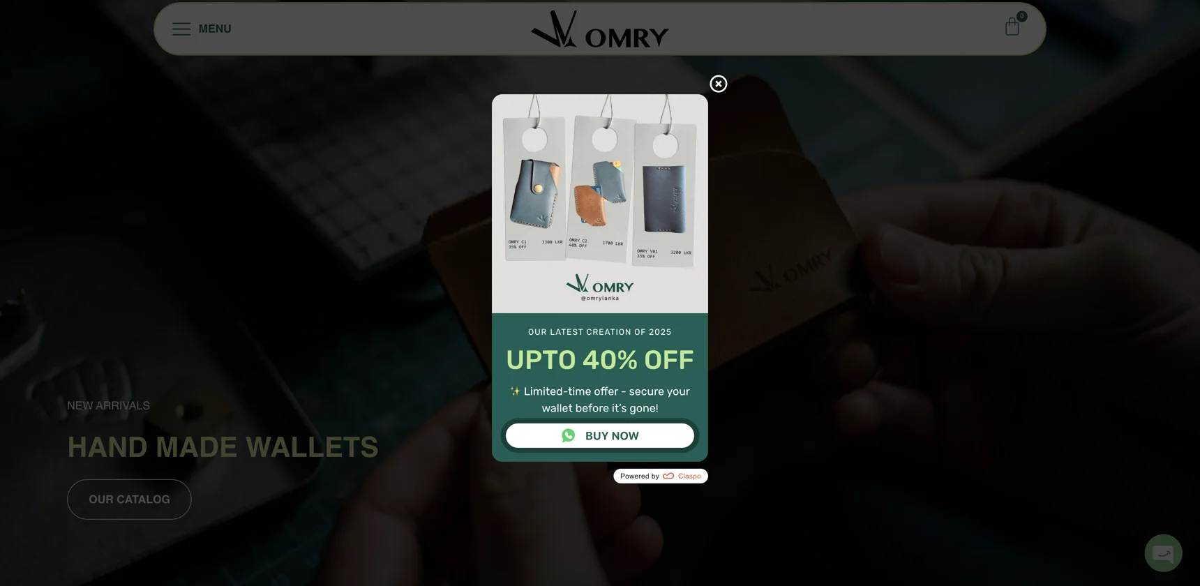 A centered e-commerce sale announcement popup by Claspo on the Omry leather goods website offering up to 40% off, featuring product imagery and a direct WhatsApp "Buy Now" conversion routing button.