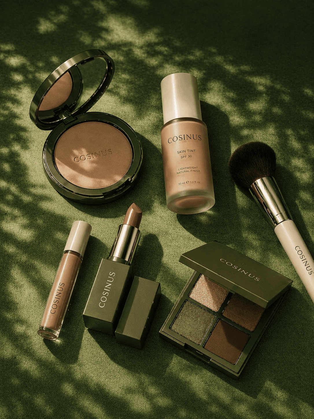 Cosinus makeup products including brushes and compacts arranged on dark background.