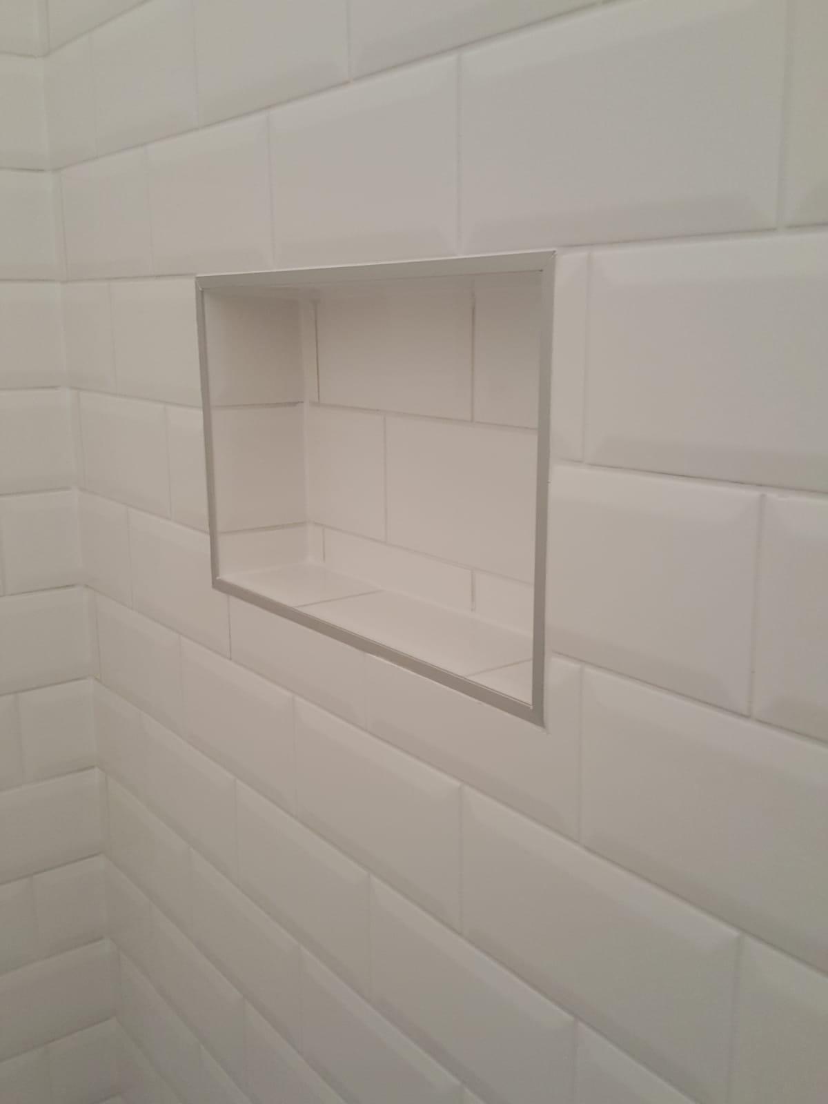 Modern urban home with cantilevered levels over a landscaped garden, featuring reflective glass and concrete design.