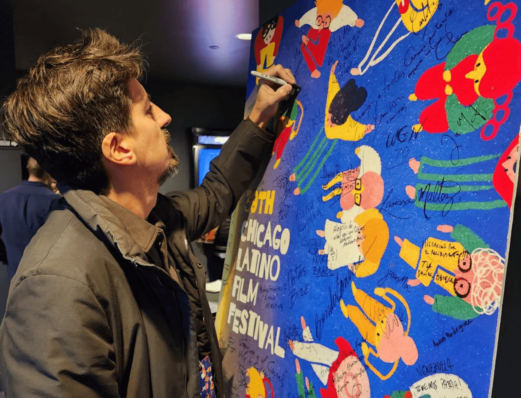 person signing a poster