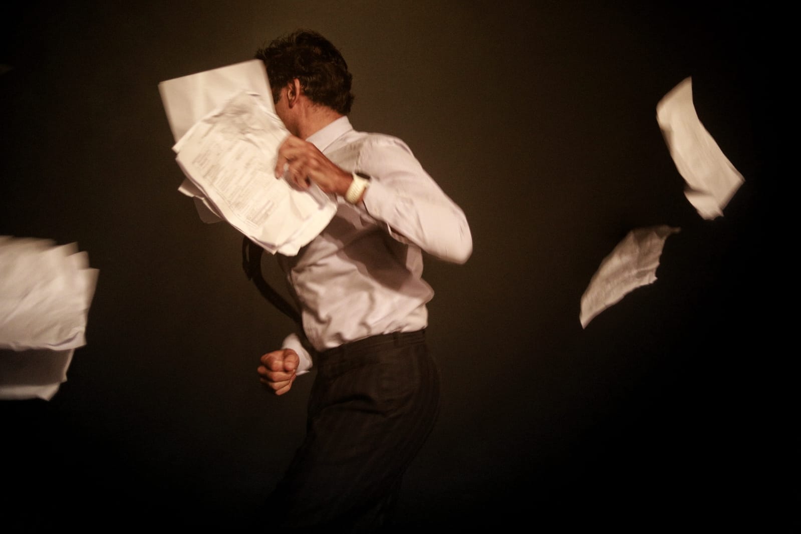 Woman in pink leather jacket crouching outdoors at night