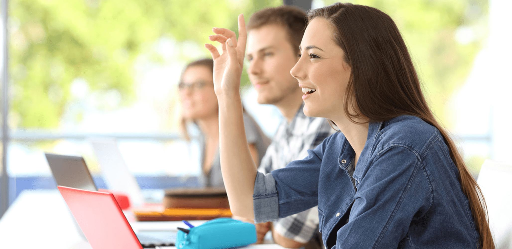 Student girl smiling and raising her hand in classroom | Let me learn