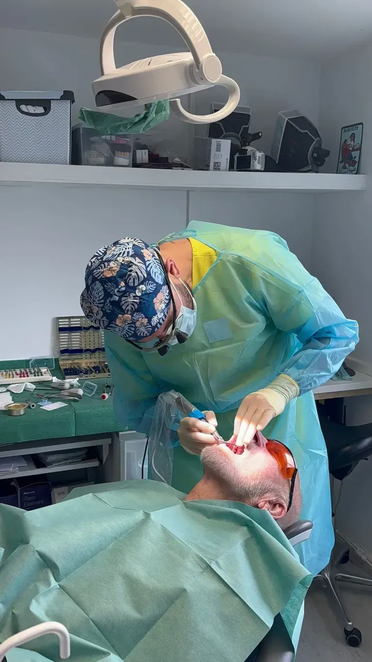 Dr Muataz in surgery doing some gum treatment or periodontal work on a patient.