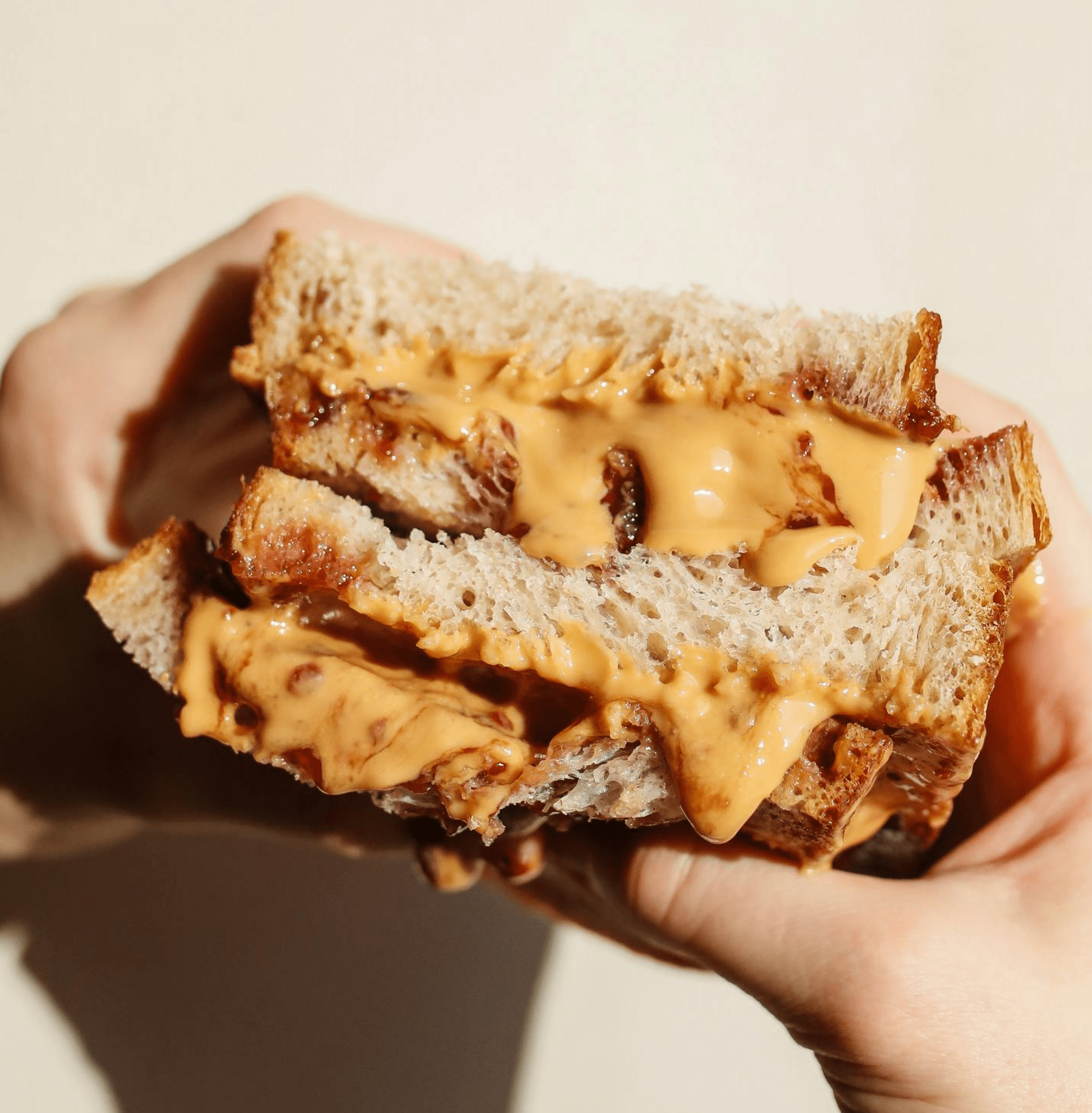 Close-up of pink serum with effervescent bubbles in a clear square glass bottle—clean skincare macro.