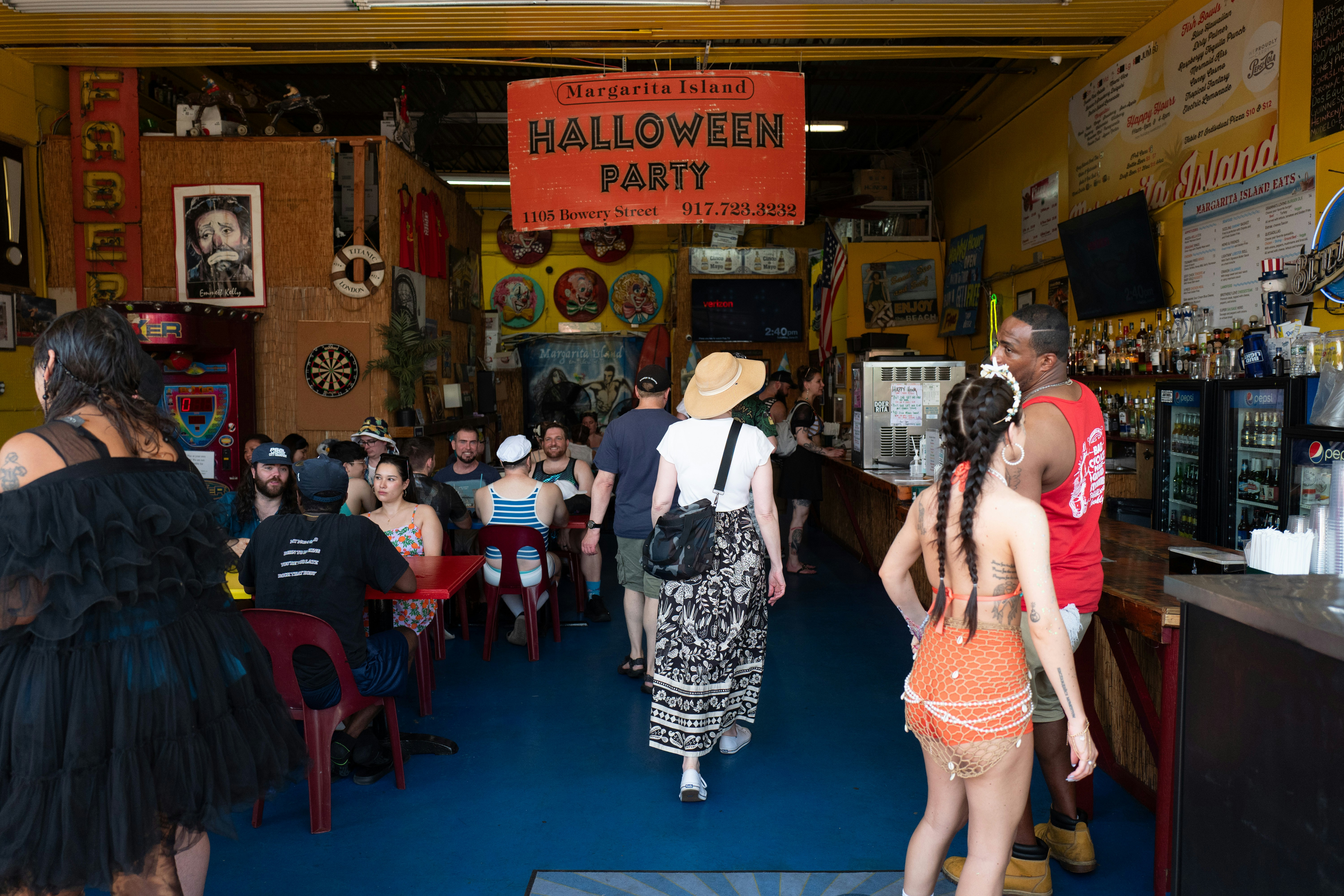 People gathered inside a lively bar with halloween decorations