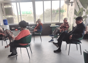 Members doing chair exercises at Aamra Seniors Club with physiotherapist