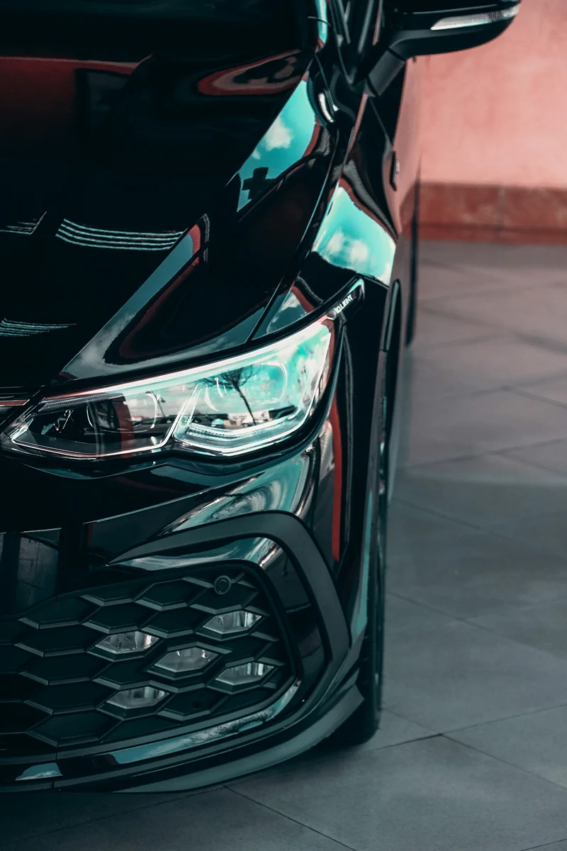 Black vehicle exterior with reflective paint finish after professional ceramic coating treatment.