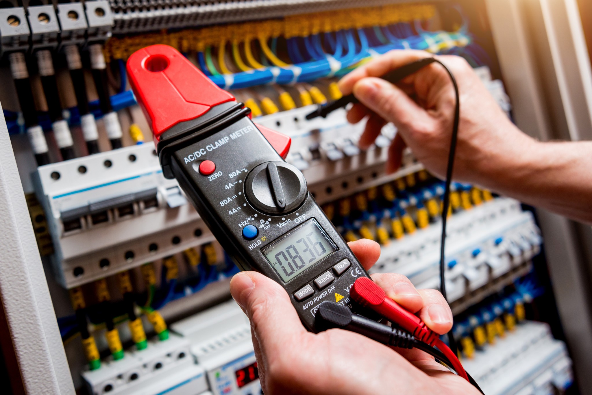 A technician performing electrical testing using specialised equipment.