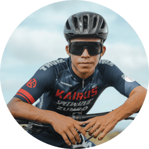 Image 1: Cyclist in Specialized jersey with sunglasses and helmet outdoors.