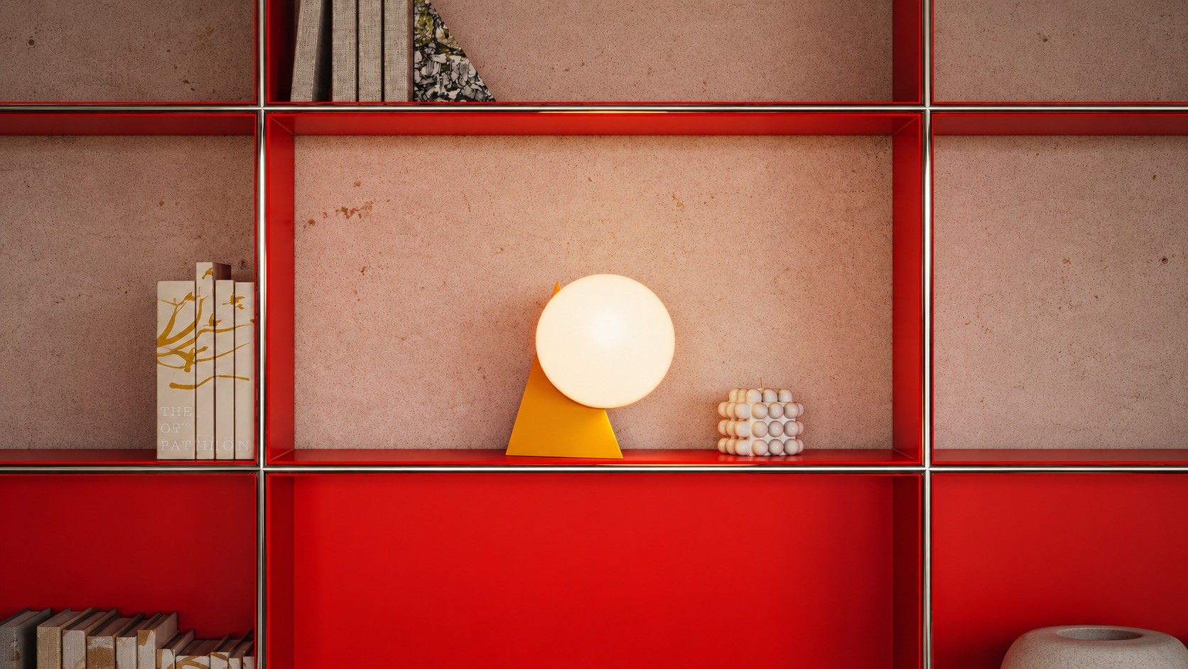 Yellow triangle table lamp with a glowing globe on a red shelving unit, between books and a bubble candle