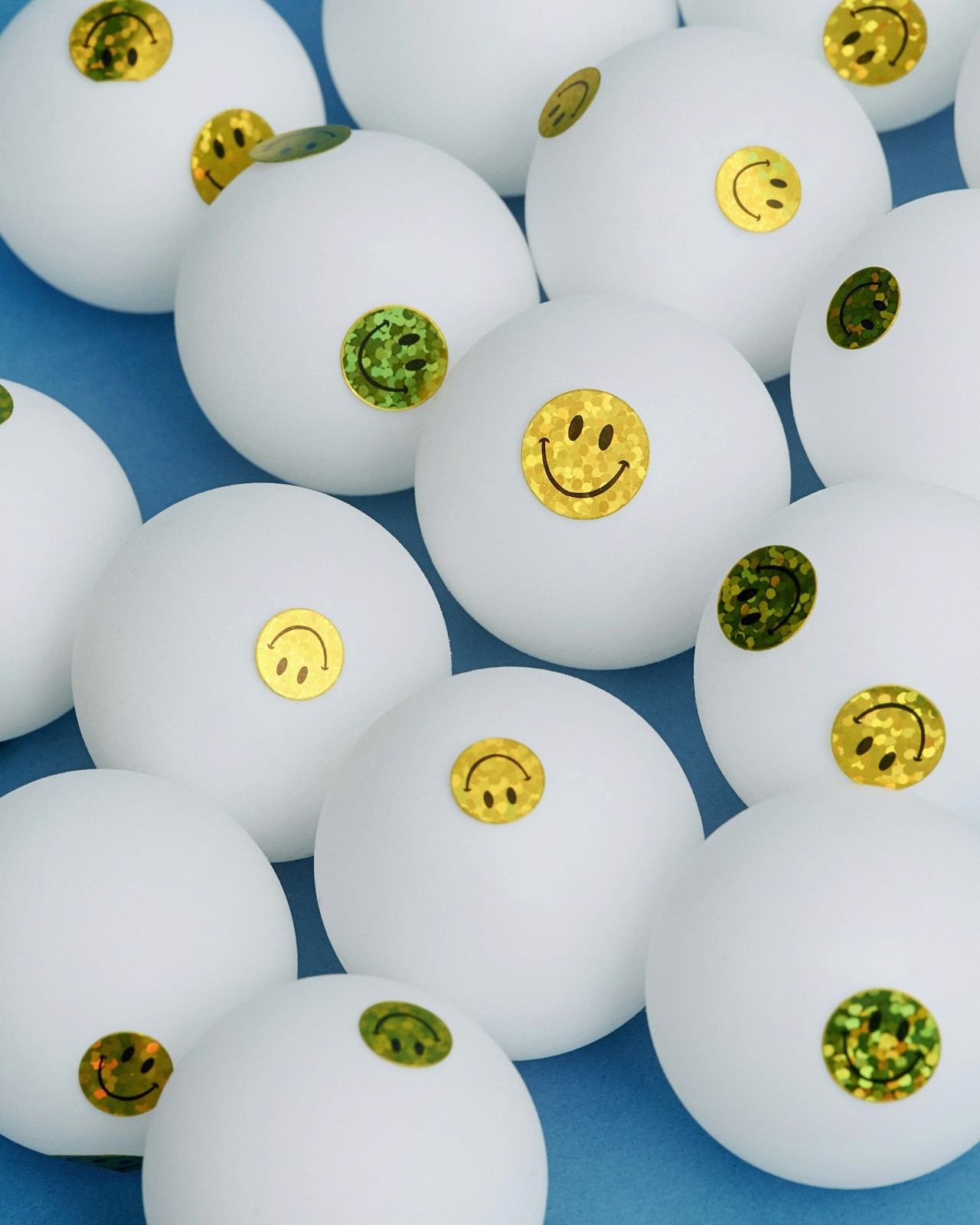 Smiling man and woman standing together in front of a framed abstract artwork.