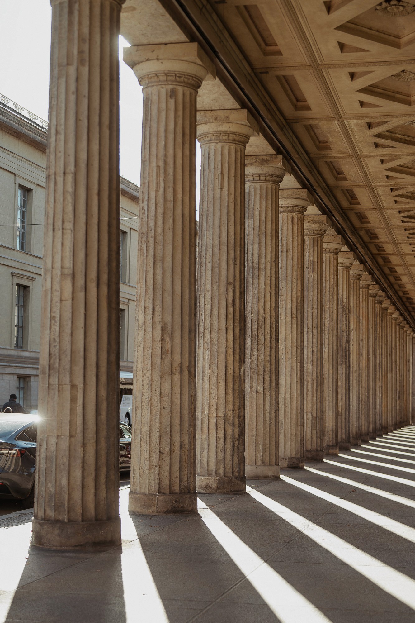 Architectural columns casting long shadows, symbolizing structure and alignment in the StoryOS narrative system