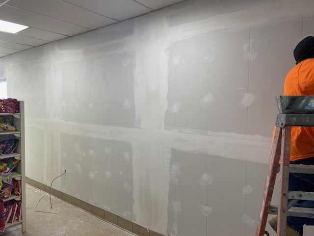 Drywall wall repair in progress.