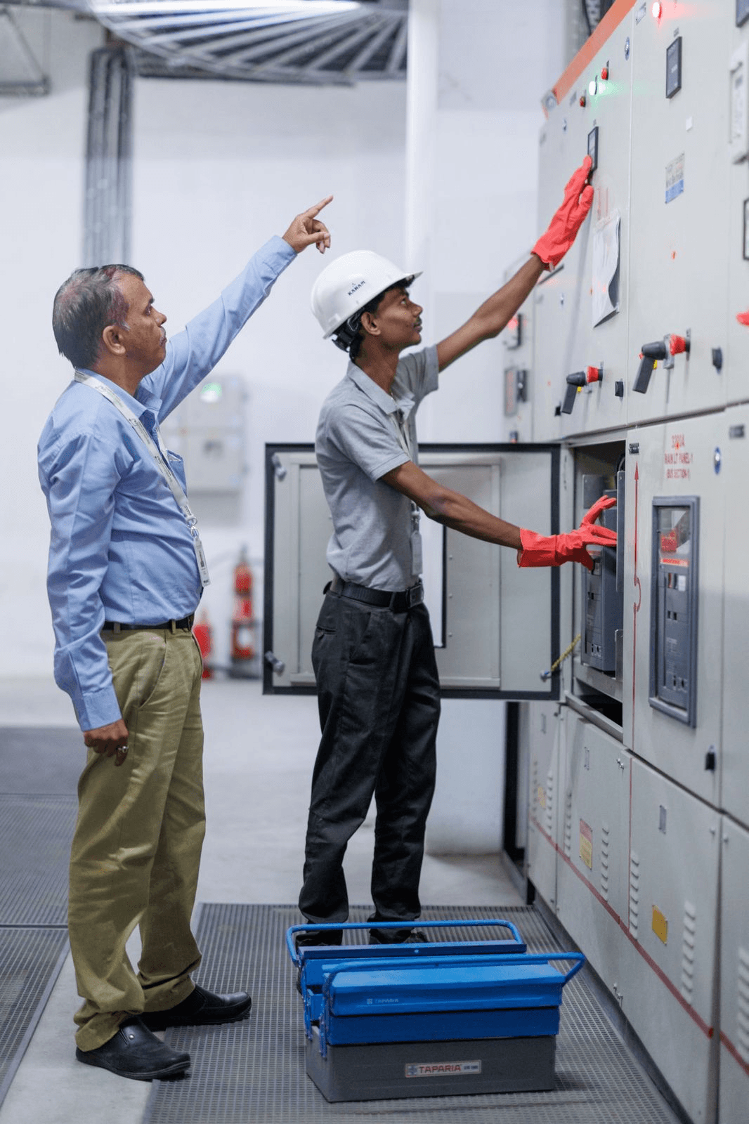 a couple of men wearing hard hats