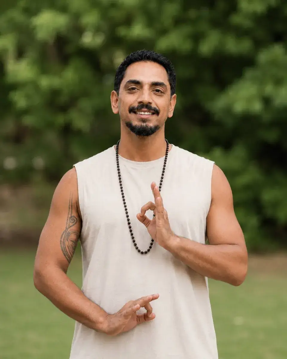 Friendly and certified yoga educator smiling in lush nature, part of our dedicated 200-hour training team in Bali.