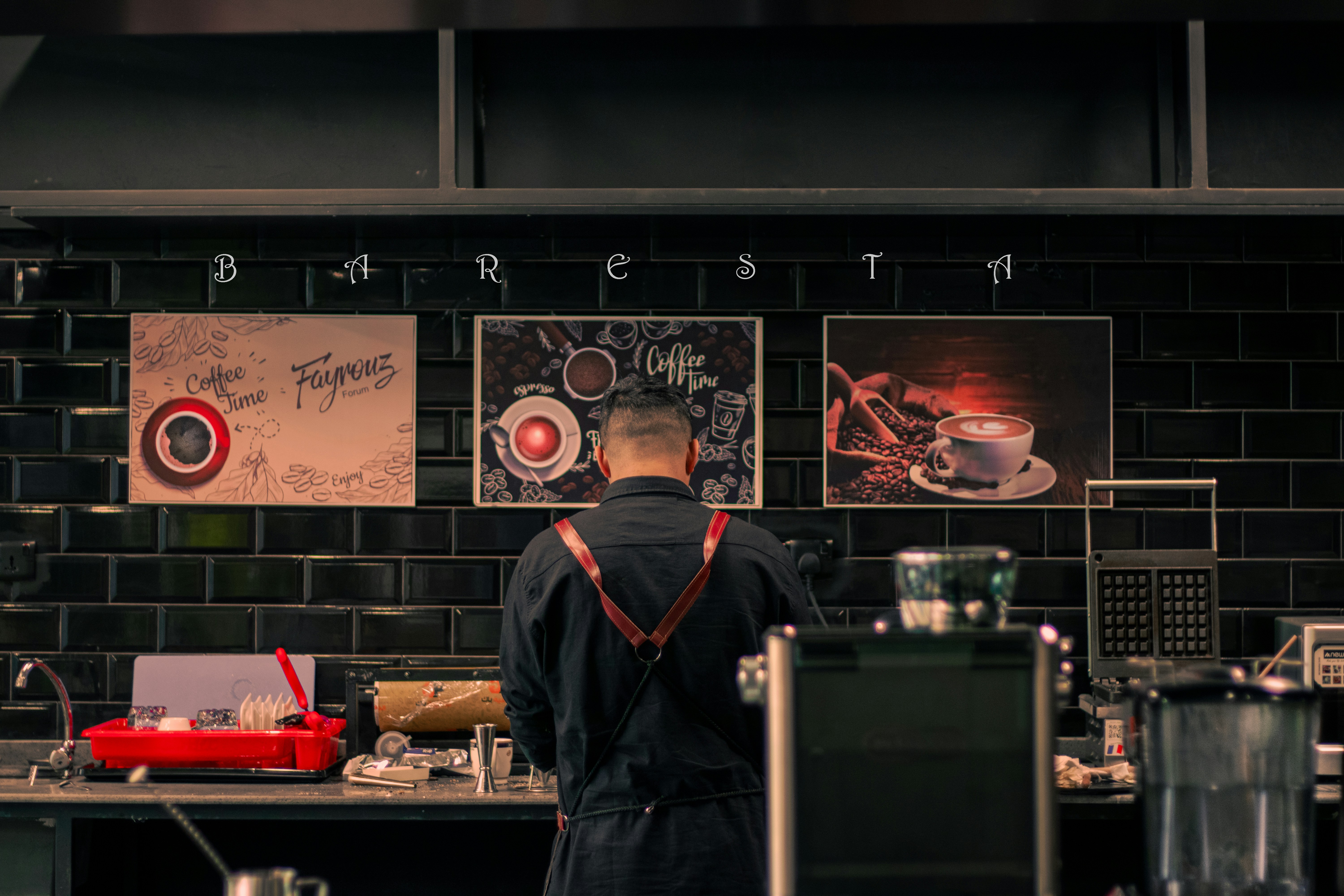 a man standing in front of a counter in a restaurant