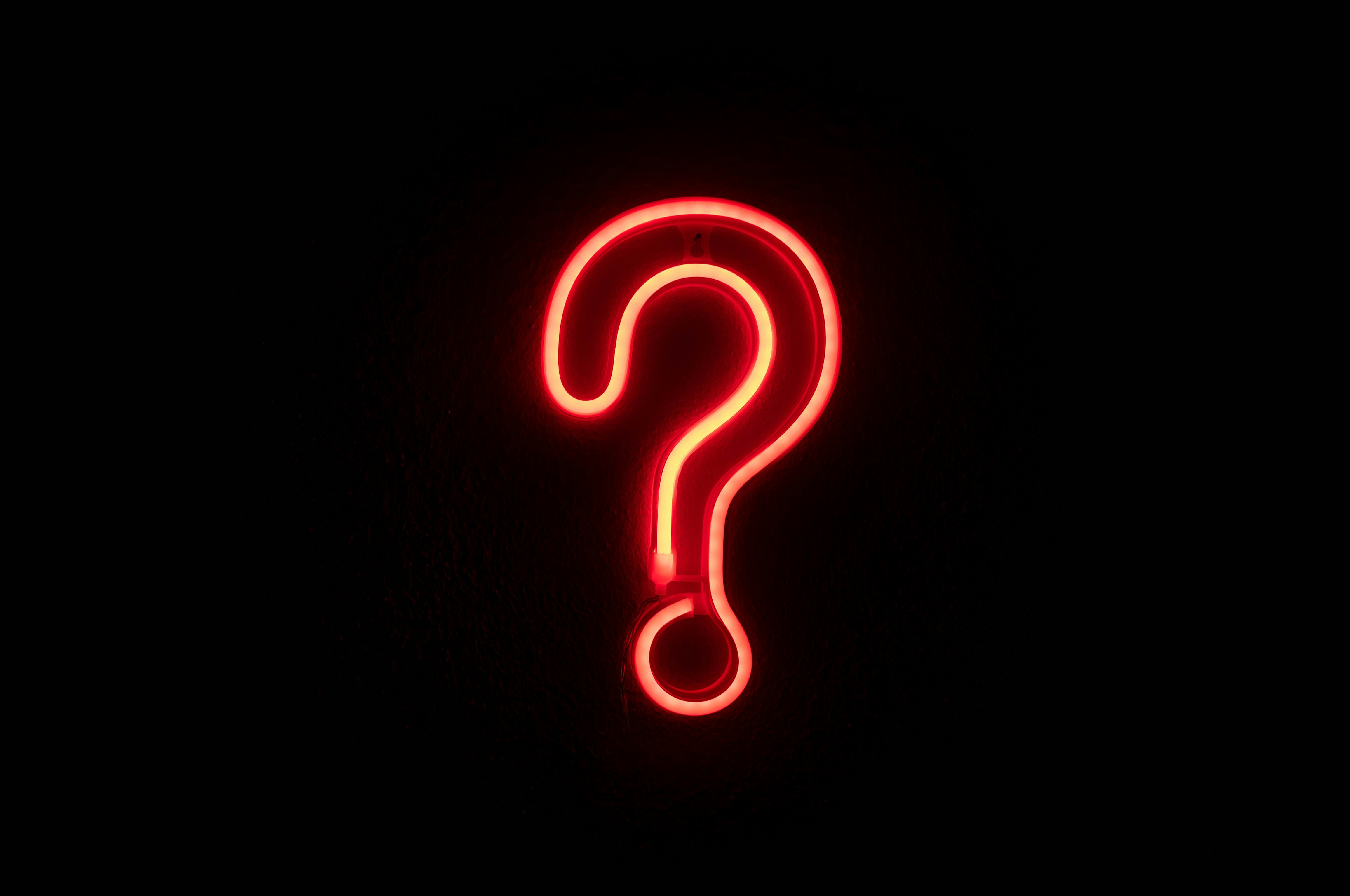 Neon question mark symbol representing unanswered questions and topic coverage gaps in AI answers