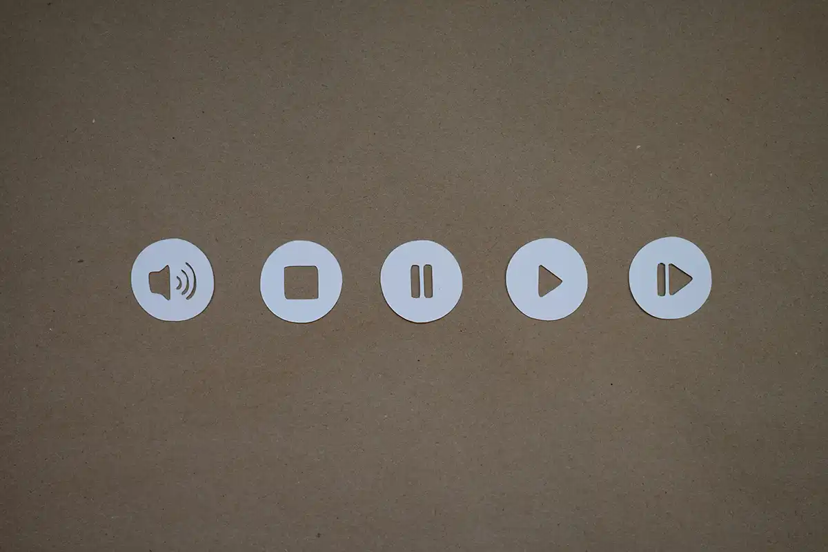 a set of four white buttons on a brown surface