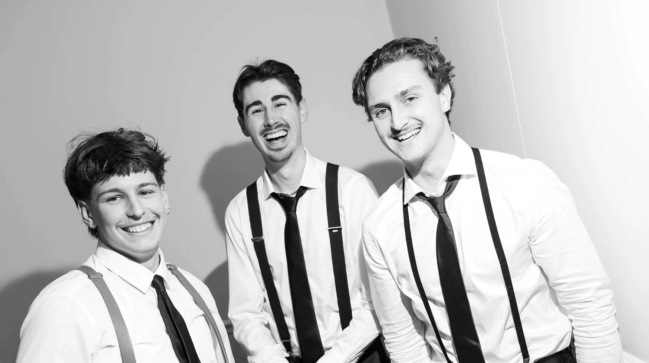 A red hot air balloon glows at sunset over mountains.