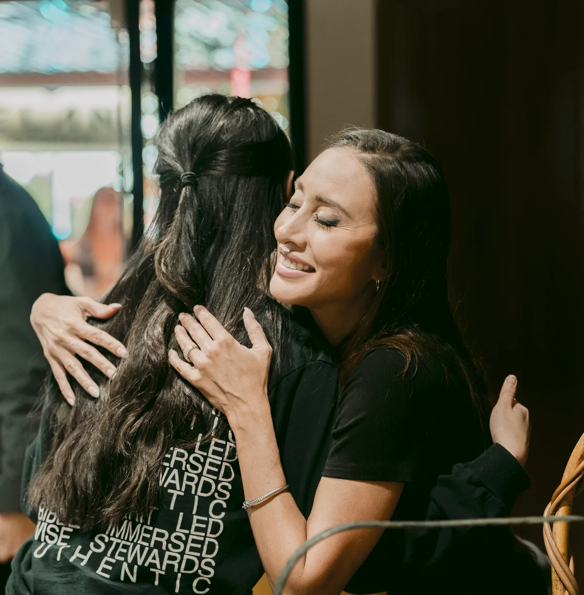 Two friends hugging in the lobby