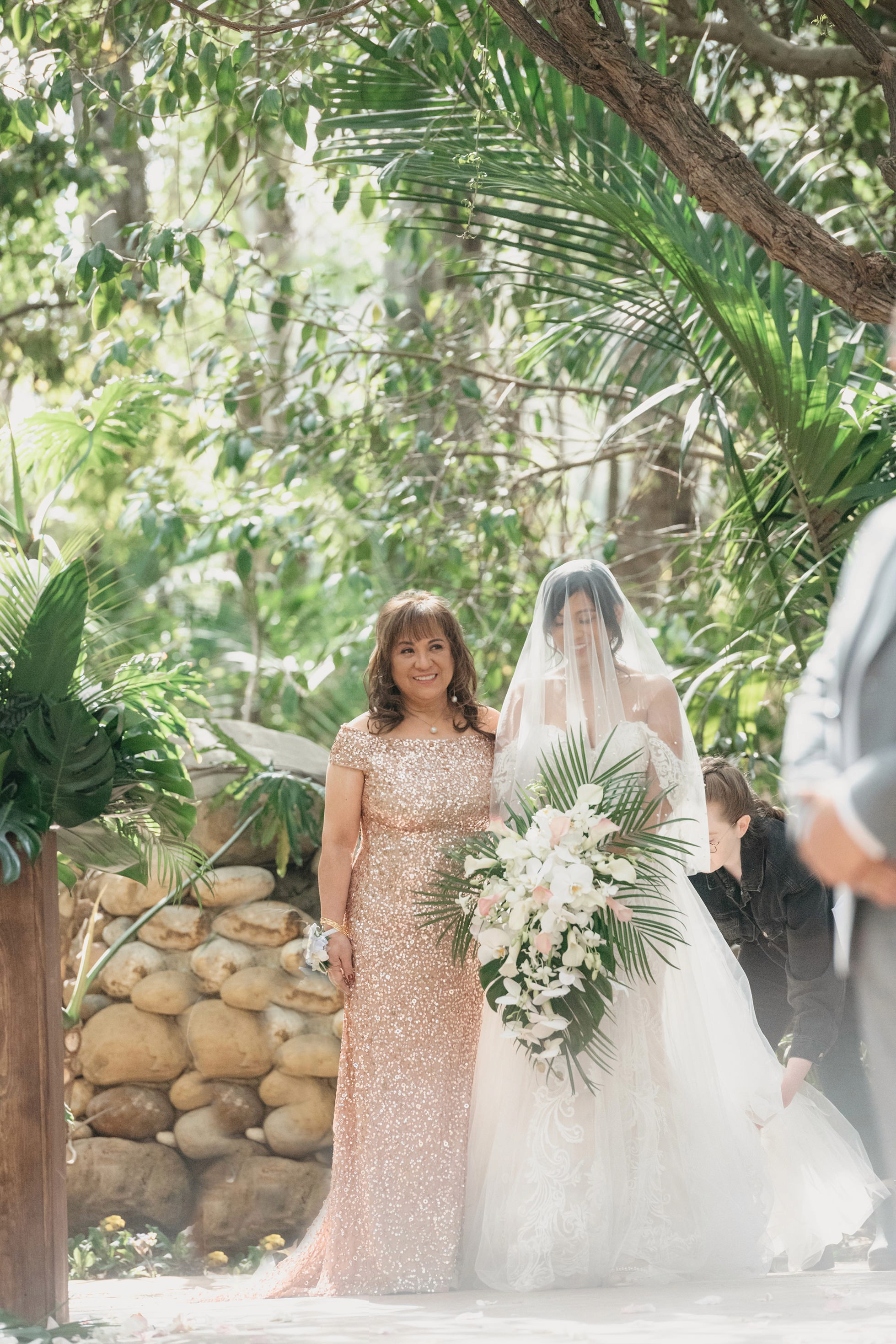 Bride walking down the aisle at outdoor garden ceremony