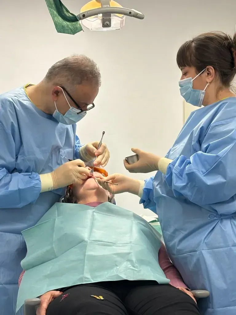 Dr Yasser and his nurse in surgery, to do some dental work on a patient.
