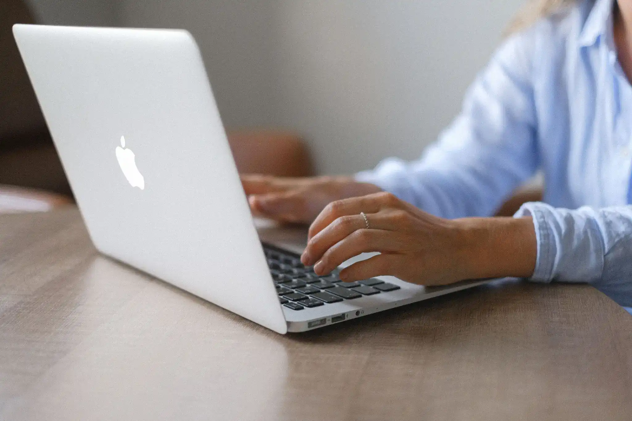 Website designer working on a laptop, representing professional website design and digital business services.