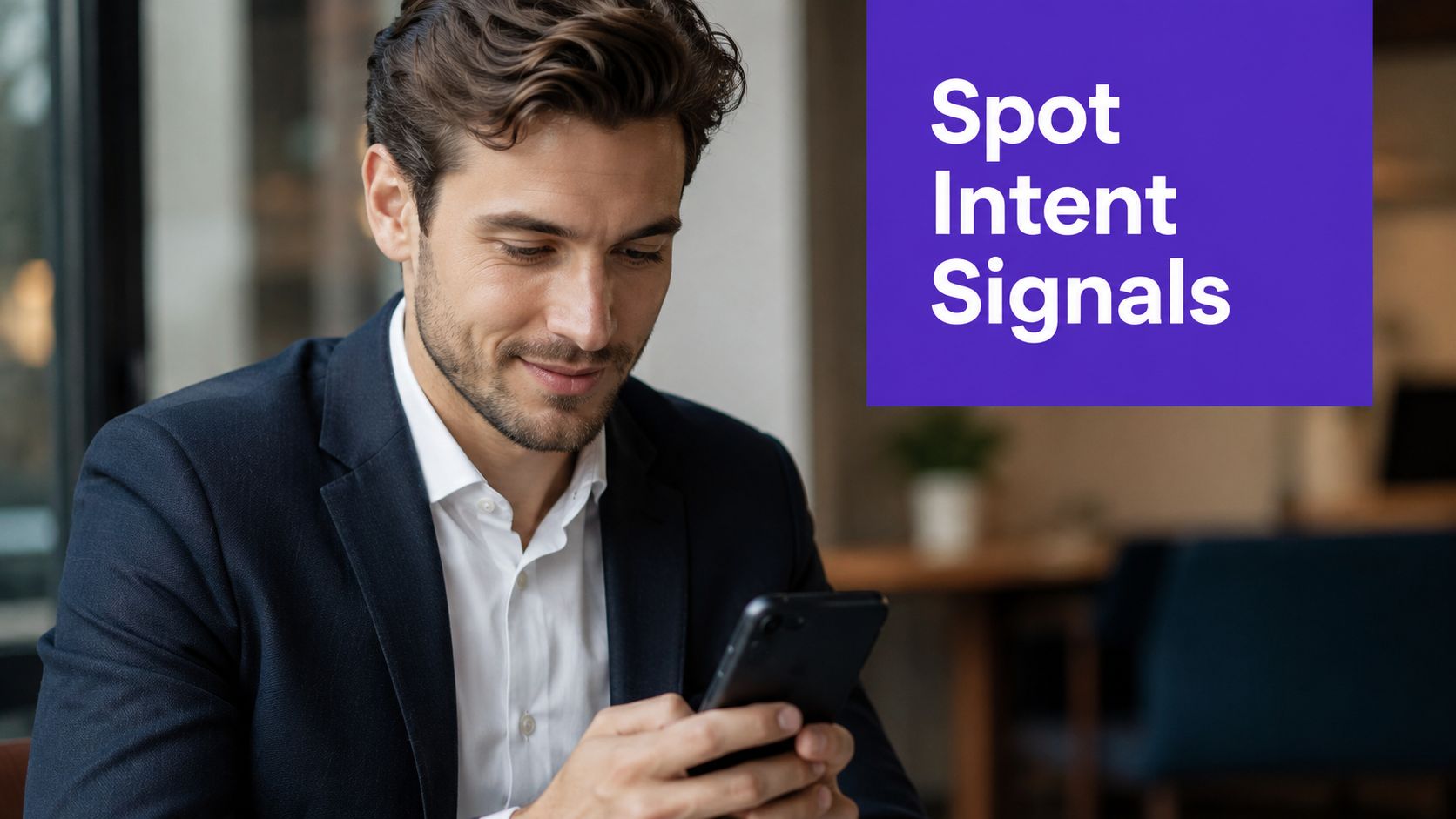 A professional man in a suit looking at his smartphone while checking for business intent signals.