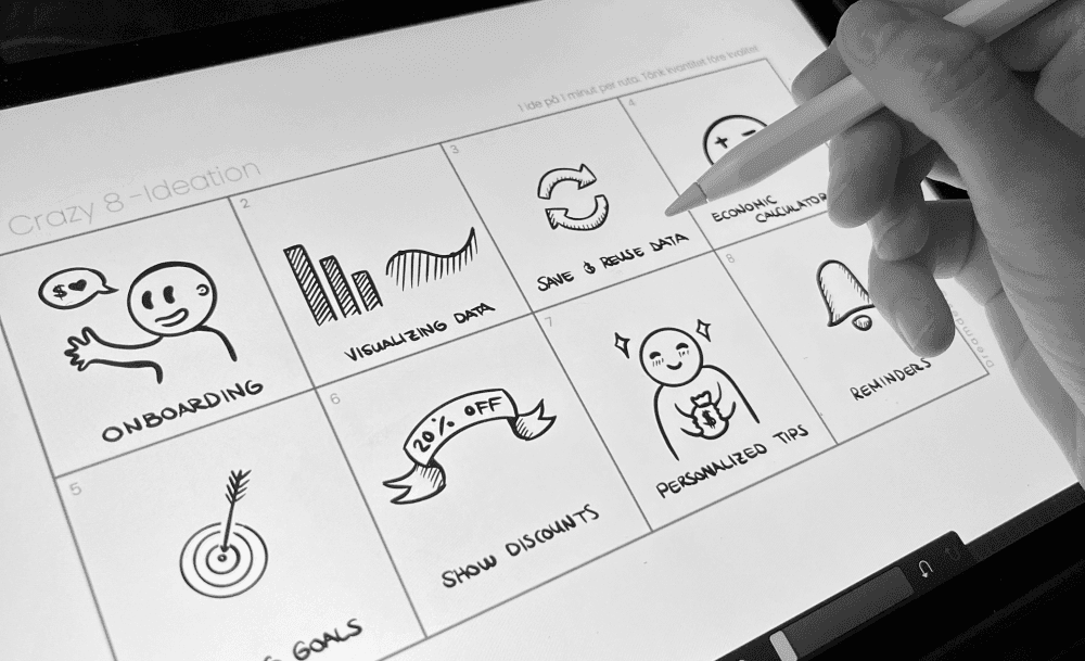 Photo showing sketches from an ideation workshop on how to personalise Compricer.