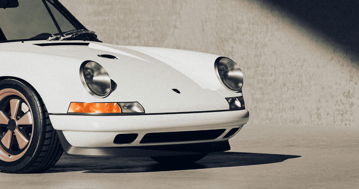 A close-up of a pink cocktail in a martini glass, set against a nighttime background with soft, blurred colors.