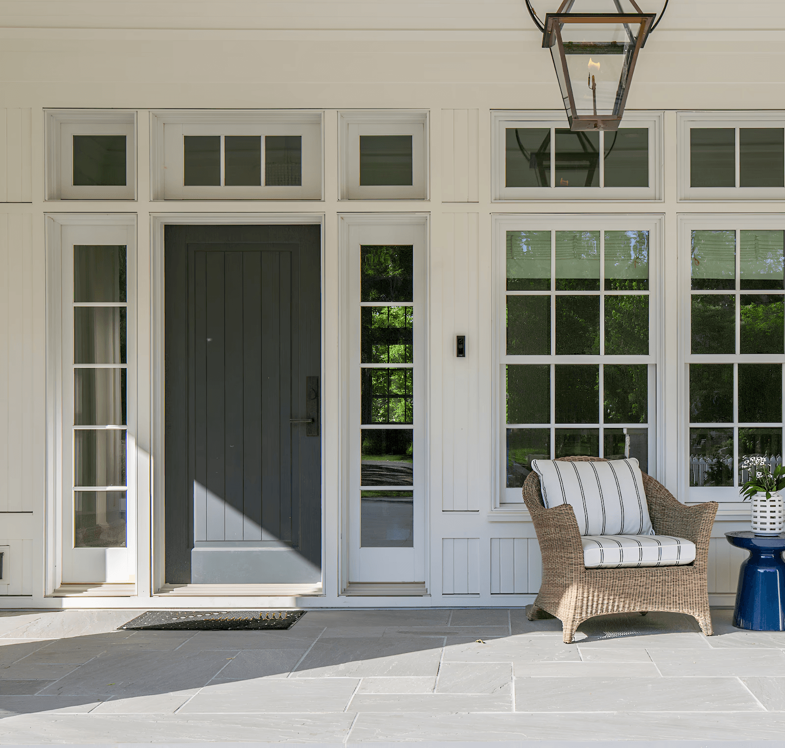 White porch with black door and white lineals.