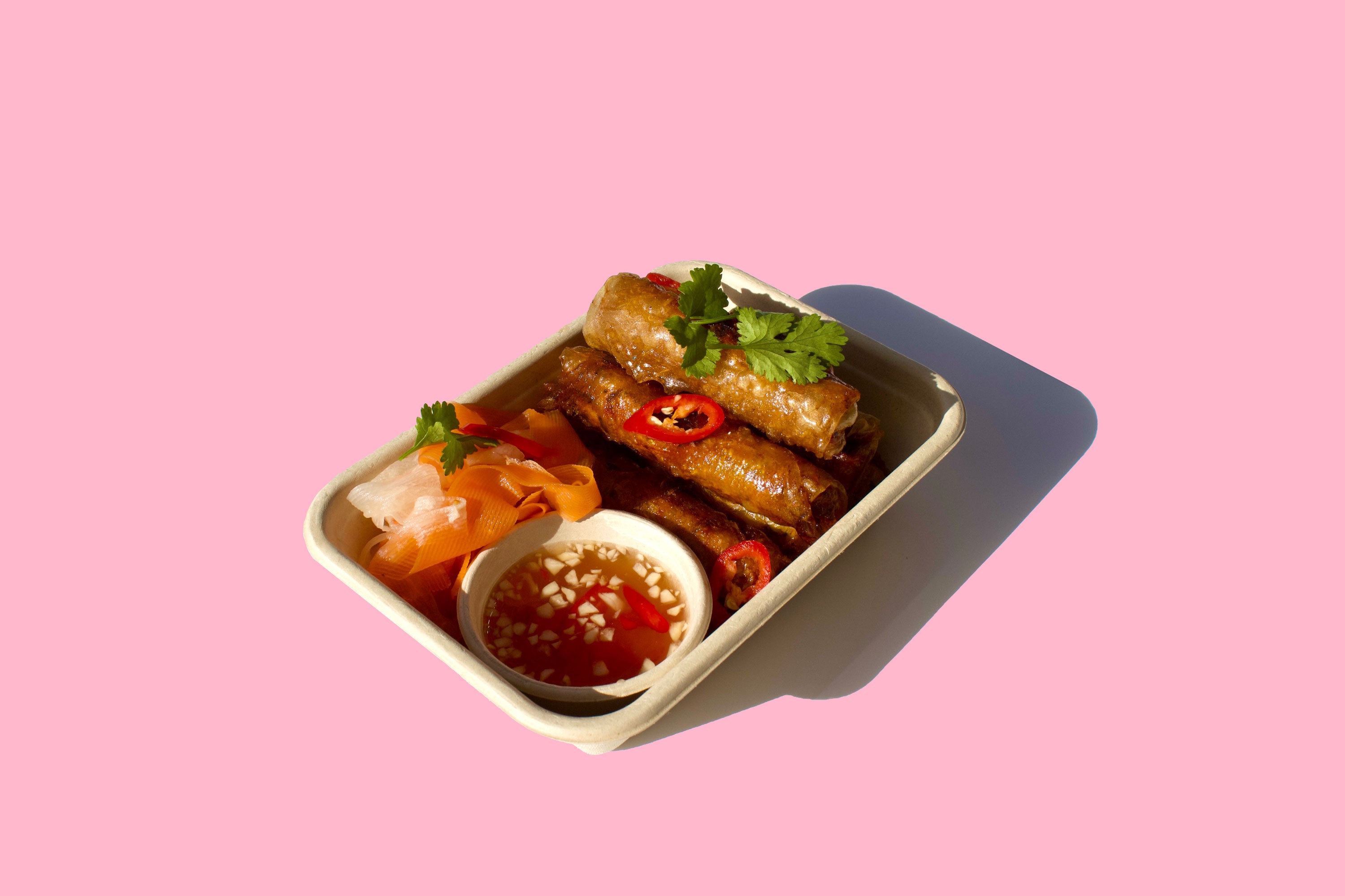 Crispy Vietnamese spring rolls (Gio Chả) served fresh with herbs – popular Asian street food in Auckland.