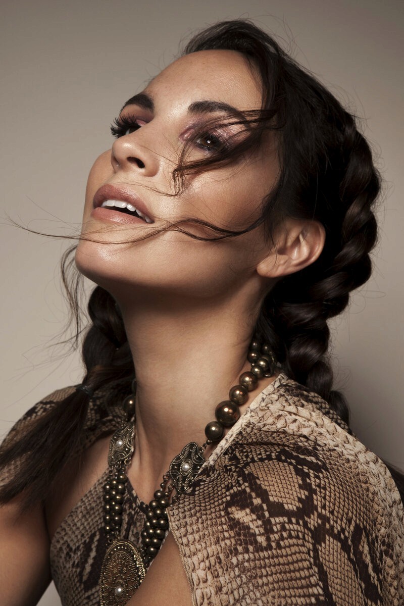 Model with glowing bronzed skin and gold jewellery for a beauty campaign, by editorial makeup artist Em-J