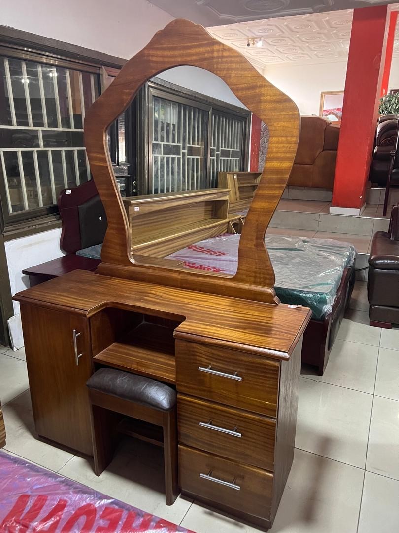 a gray couch with a wooden base on a gray background
