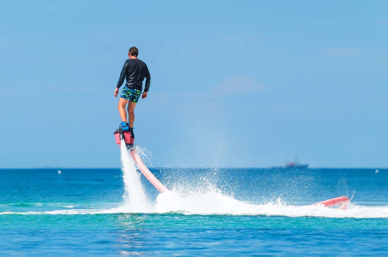man riding water sports board