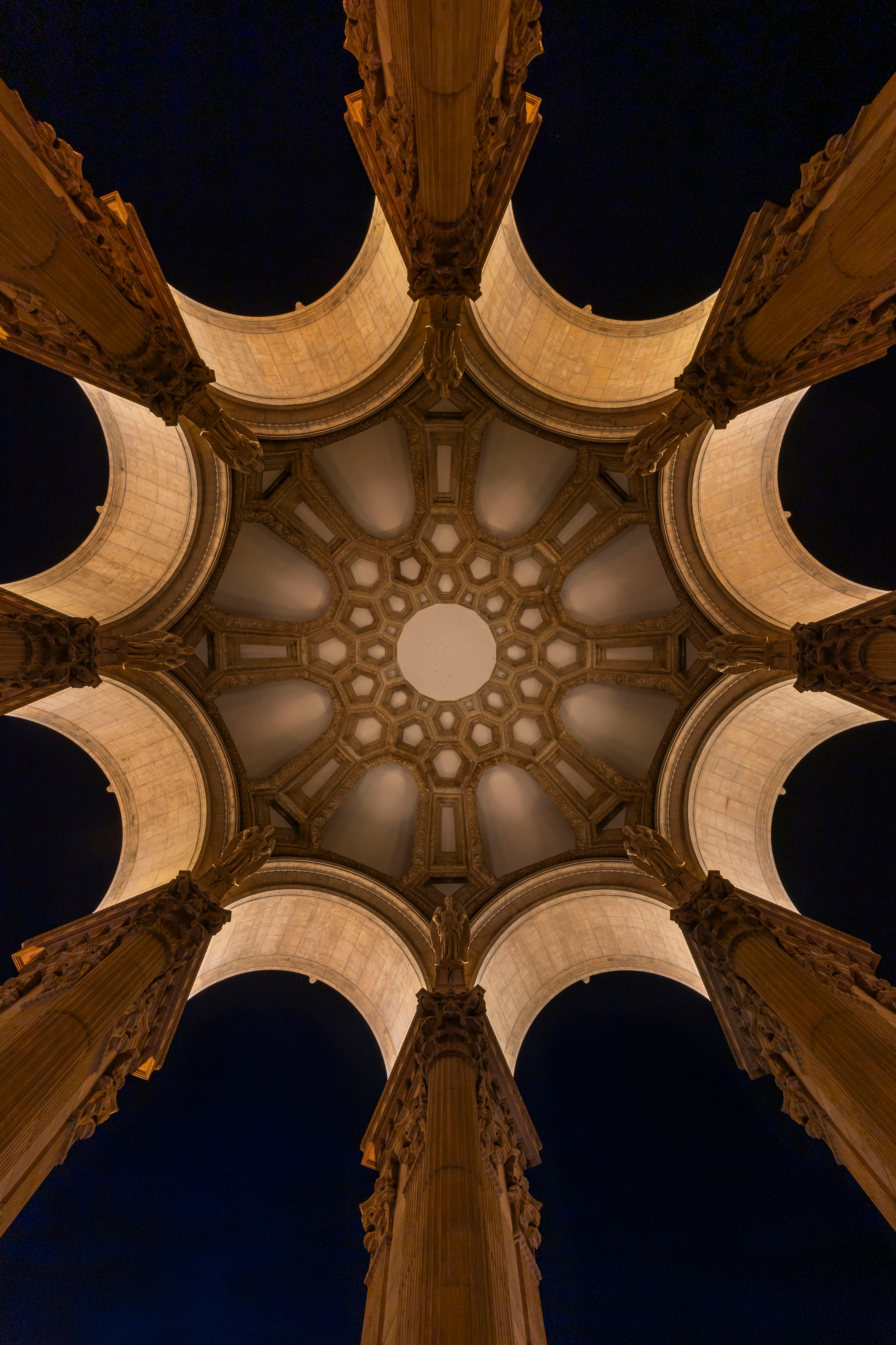 Looking up at a grand domed ceiling with columns