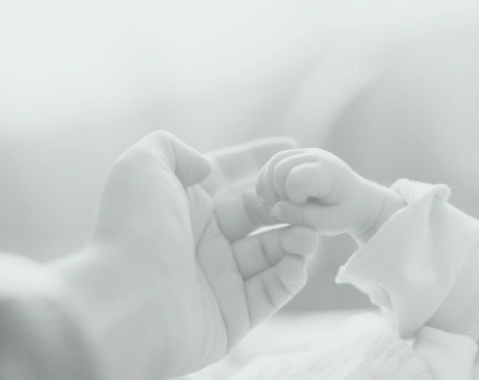 mother holding baby's hand