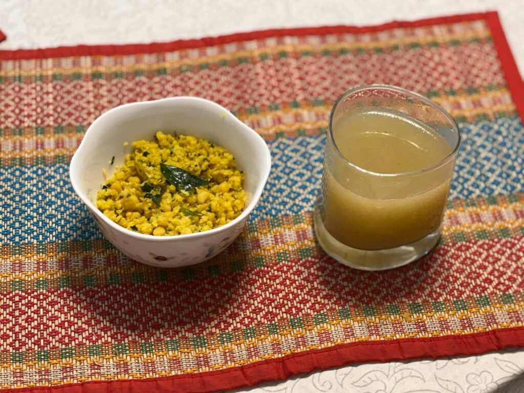 Chana dal and raw mango salad, known as ambe dal served with a raw mango drink, known as panha