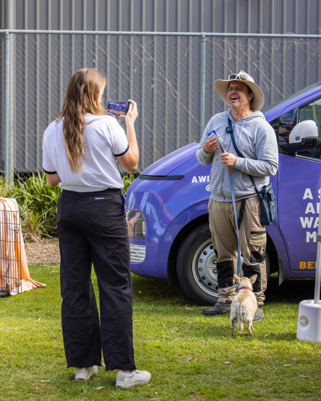 Young woman interviewing man and dog