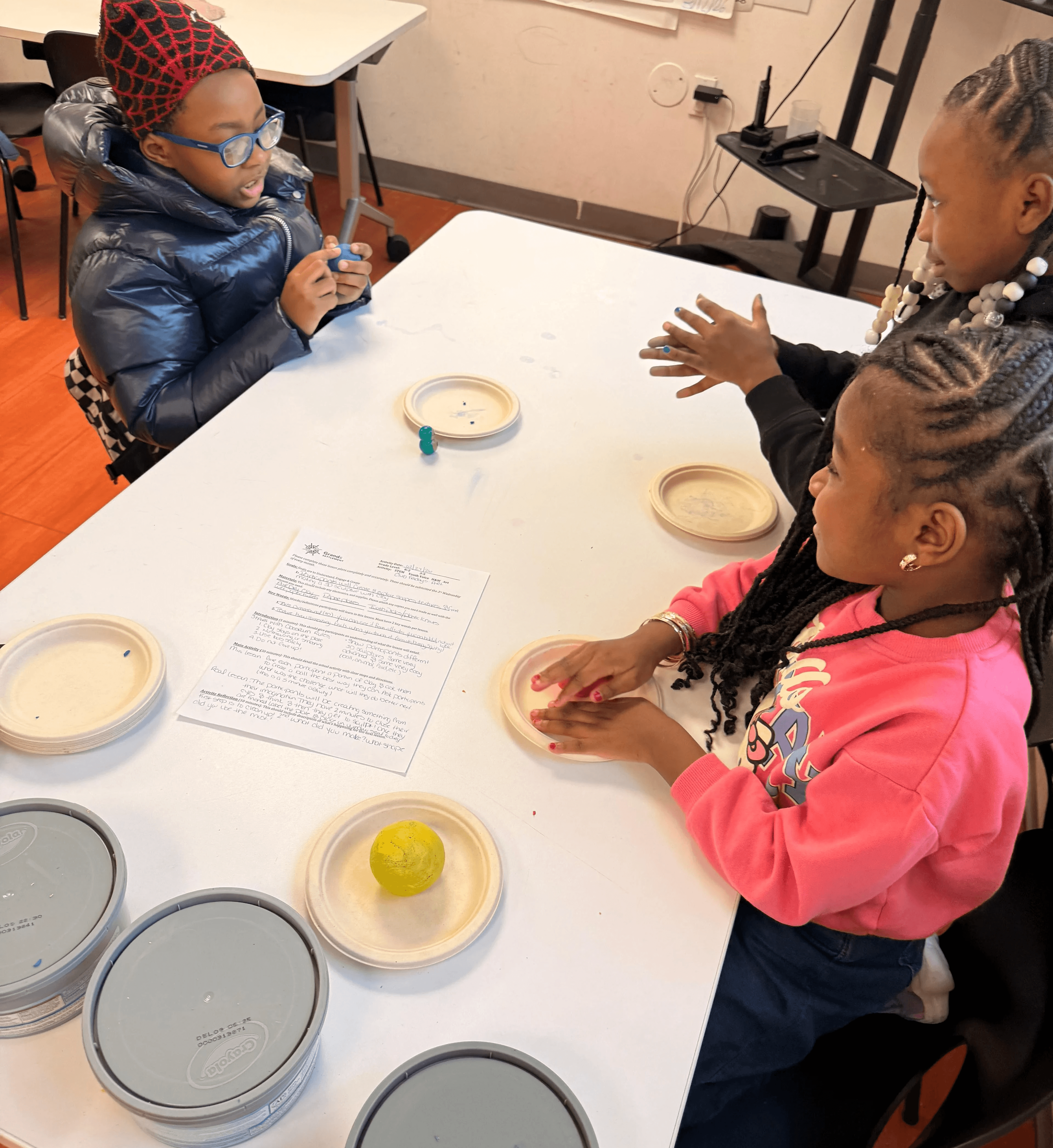 Afterschool participants work on their clay sculptures..