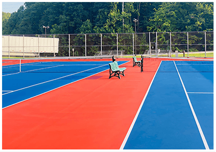 Resurfaced tennis courts in Evansville, Indiana with red and blue acrylic surface