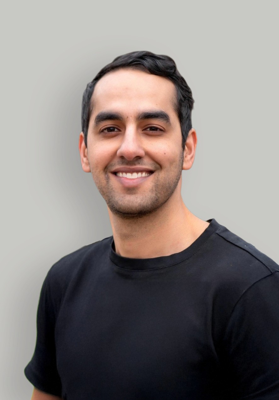 A woman with straight blonde hair wearing a light colored sweater looks away.