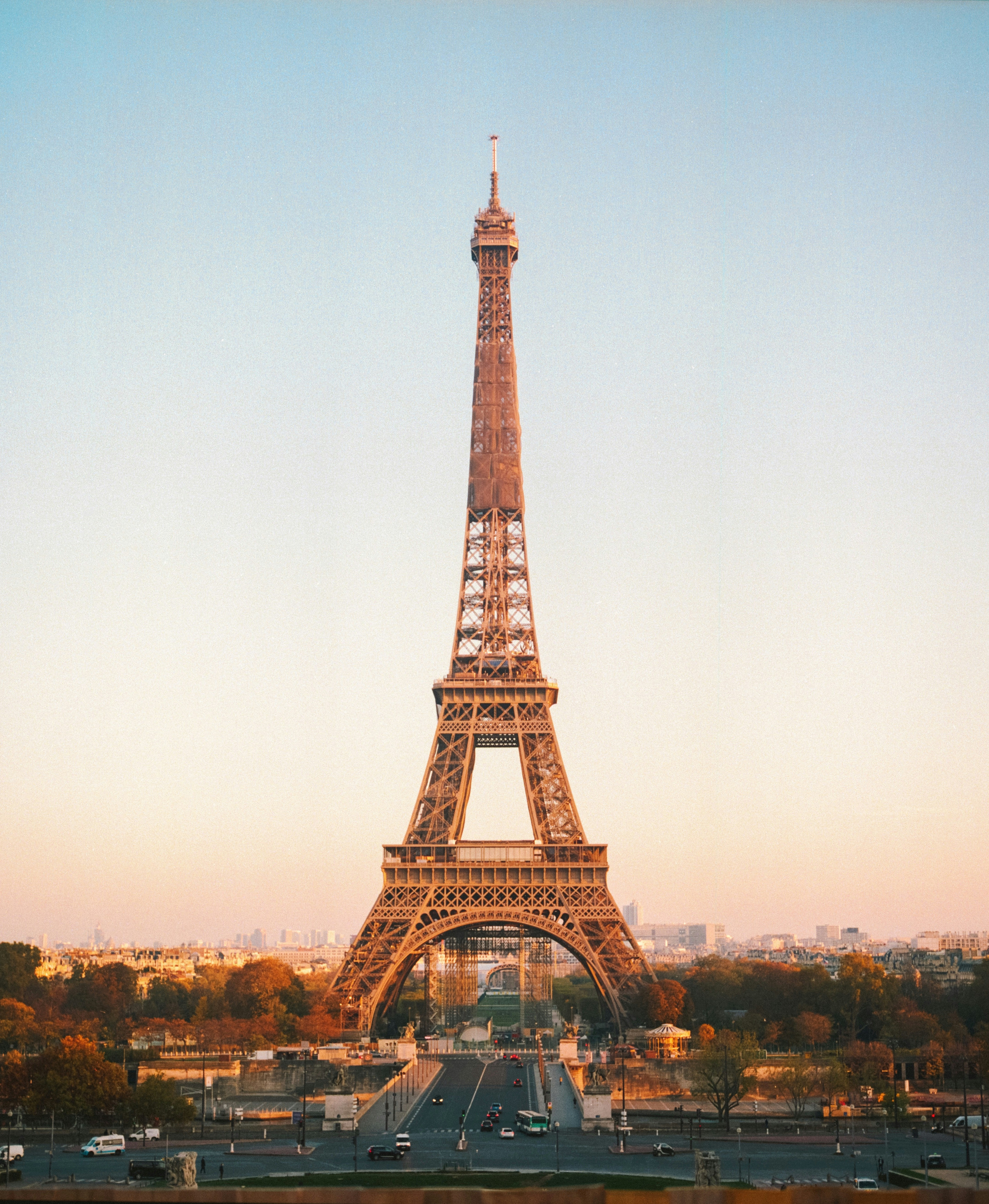 A photo of the Eiffel Tower at sunrise from the distance