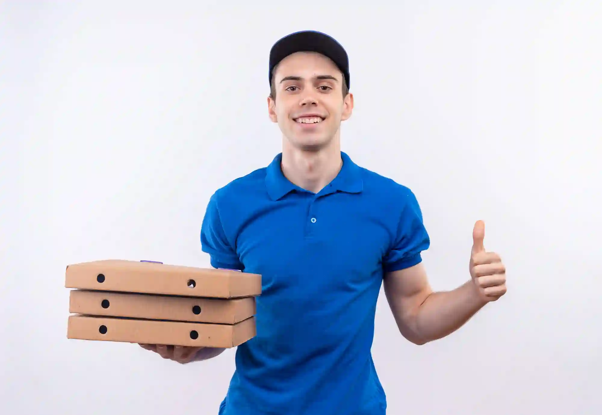 Smiling pizza delivery worker in a blue uniform holding three pizza boxes and giving a thumbs up.