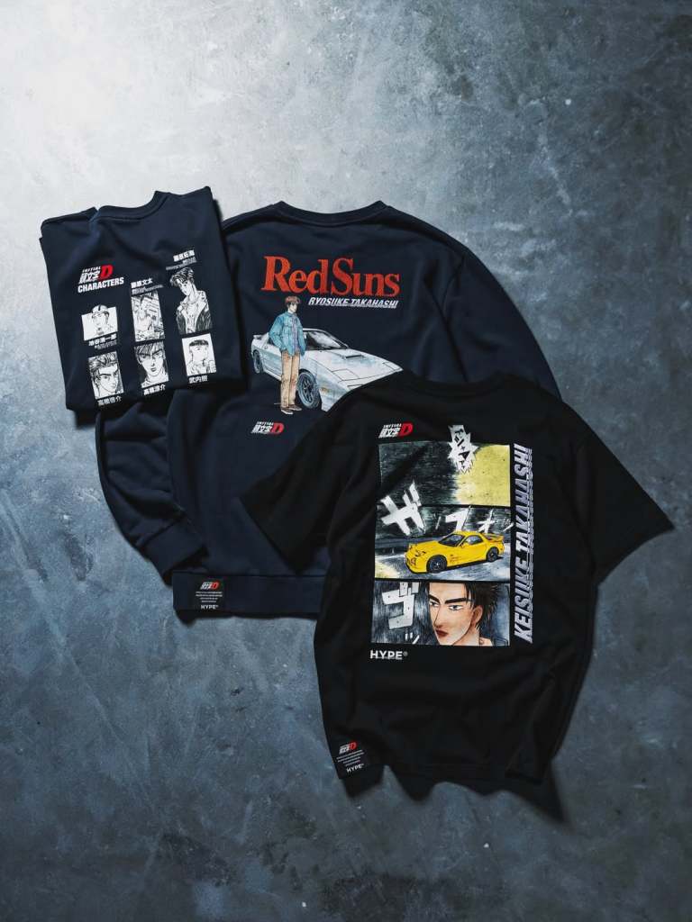 A collection of streetwear featuring designs inspired by the anime Initial D, showcasing graphics of characters and cars on dark clothing.