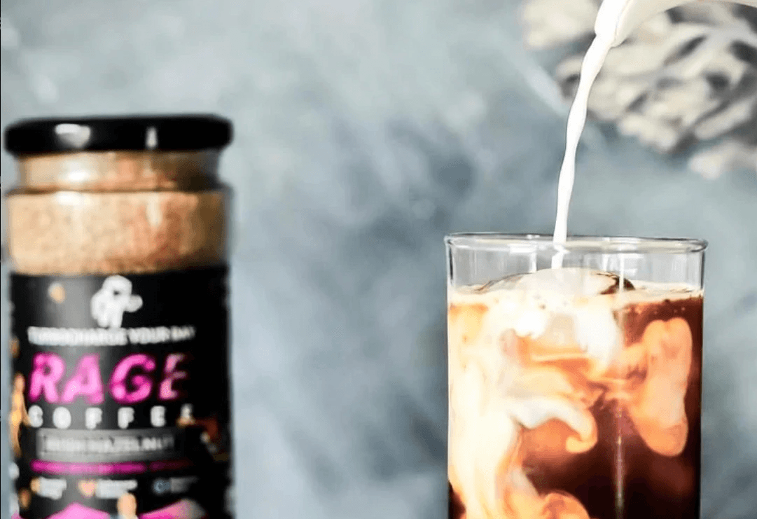 A glass of coffee with the instant coffee in background