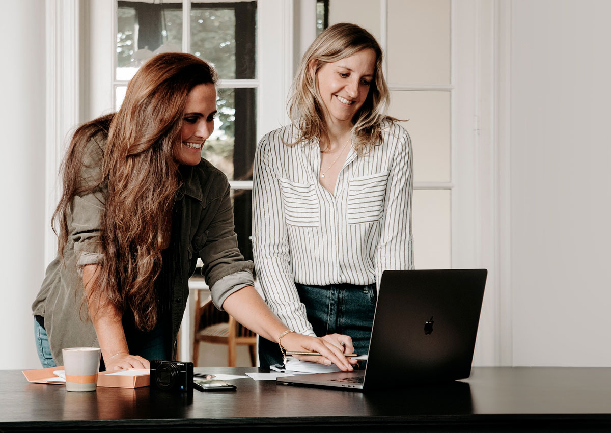 Black futuristic car in front of a modern building with glass front